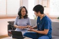 A health visitor is using a tablet to explain to a sick elderly woman how to take her pills.The visitor is taking Royalty Free Stock Photo