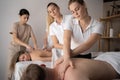 Health wellness massage training.Teacher helping student training to become masseuse Royalty Free Stock Photo