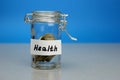 Health word on piggy Bank, moneybox, money jar with coins Royalty Free Stock Photo