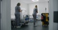 Health worker brings cleaning trolley to hospital ward