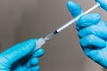 A health worker inserts a vaccine or antibiotic into a syringe in order to administer it. Close-up of the hands Royalty Free Stock Photo