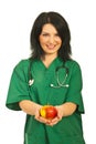 Health worker offering apple Royalty Free Stock Photo