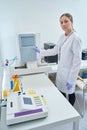 Health worker turns on the hematology analyzer Royalty Free Stock Photo