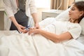 Health worker uses small sphygmomanometer to measureblood pressure teenage girl Royalty Free Stock Photo