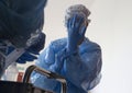 A Health worker adjust her gloves