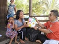 Health workers are providing assistance in the form of biscuits to mothers of toddlers