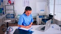 Healthcare assistant taking notes on clipboard working in hospital Royalty Free Stock Photo