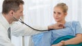 Healthcare background of physical doctor examining patient with stethoscope at hospital