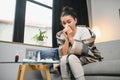 healthcare, cold, allergy and people concept - sick woman blowing her runny nose in paper tissue at home. Royalty Free Stock Photo