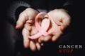 Healthcare concept - child hands holding cancer awareness ribbon Royalty Free Stock Photo