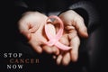 Healthcare concept - child hands holding cancer awareness ribbon Royalty Free Stock Photo