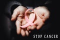 Healthcare concept - child hands holding cancer awareness ribbon Royalty Free Stock Photo