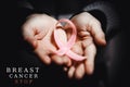 healthcare concept - child hands holding cancer awareness ribbon Royalty Free Stock Photo