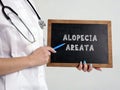 Healthcare concept meaning ALOPECIA AREATA with sign on the chalkboard