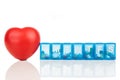 Healthcare concept with pill organizer box for storing doses of daily medicine, with red heart as prop Royalty Free Stock Photo