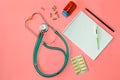 A stethoscope, thermometer, pills and notepad on doctor table or nurse desk Royalty Free Stock Photo