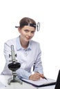 Healthcare Concepts. Professional Laboratory Female Researcher in Smock Working With Microscope While Conducting a Research and