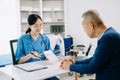 Healthcare costs and fees concept.Hand of smart doctor used a calculator and smartphone, tablet for medical costs at hospital Royalty Free Stock Photo