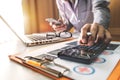 Hand of smart doctor used a calculator and tablet for medical costs Royalty Free Stock Photo