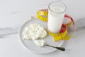 Healthcare and eating health food.Watch your figure and waistline.Measure tape,milk,cottage cheese Royalty Free Stock Photo