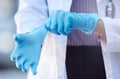 Healthcare, hand of doctor and surgery with surgical gloves for protection at a hospital. Procedure or ppe, health and