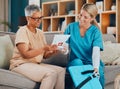Healthcare, home visit and woman with doctor on sofa or doctors visit in house living room. Senior care, nurse or Royalty Free Stock Photo