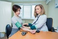 Healthcare, hospital medicine concept - doctor and patient measuring blood pressure