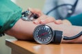 Healthcare, hospital medicine concept - doctor and patient measuring blood pressure