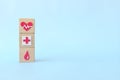 Healthcare icons on wooden blocks with copy space. Health top priority and medical insurance concept.