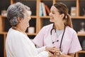 Healthcare, insurance and a senior woman patient and nurse consulting during a checkup in a retirement home. Medical