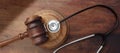 Healthcare Law. Medical stethoscope and judge gavel on lawyer office desk. 3d render