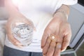 Healthcare and medical concept. Close-up view of man holding pills in one hand and glass of water in the another hand Royalty Free Stock Photo