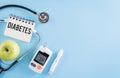 Healthcare and medical concept, Stethoscope and blood glucose meter sets on blue background, World Diabetes day, 14 November