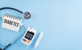 Healthcare and medical concept, Stethoscope and blood glucose meter sets on blue background, World Diabetes day, 14 November