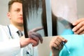 Healthcare, medical and radiology concept - Male doctors looking at x-ray of foot Royalty Free Stock Photo