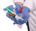 Close up of male doctor hands in protective gloves holding syringes, antiseptic, thermometer over white background