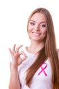 Woman pink cancer ribbon on chest making ok sign