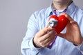 Healthcare and medicine concept - close up of male doctor hands holding red heart and medical stethoscope Royalty Free Stock Photo