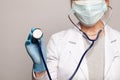 Healthcare and medicine concept. Doctor hand in blue medical glove holding stethoscope Royalty Free Stock Photo