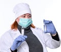 Healthcare and medicine concept. Female doctor in mask  holding syringe and ampoule Royalty Free Stock Photo