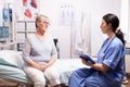 Healthcare nurse telling senior woman diagnosis Royalty Free Stock Photo