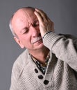 Healthcare, pain, stress and age concept. Sick old man. Senior man suffering from headache