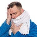 Sick man in a bathrobe wrapped in a towel over white background