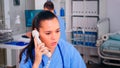 Healthcare physician answering telephone in hospital reception