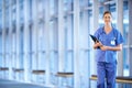 Healthcare, portrait of woman doctor and clipboard standing in a hospital smiling for protection. Nursing, health Royalty Free Stock Photo