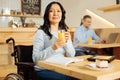 Thoughtful handicapped woman drinking juice