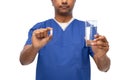 doctor or male nurse with medicine pill and water Royalty Free Stock Photo