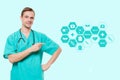 Healthcare, profession, symbols, people and medicine concept - smiling male doctor in coat over blue background with Royalty Free Stock Photo