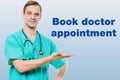 Healthcare, profession, symbols, people and medicine concept - smiling male doctor in coat over blue background with Royalty Free Stock Photo