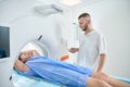 Healthcare professional is positioning patient for computed tomography